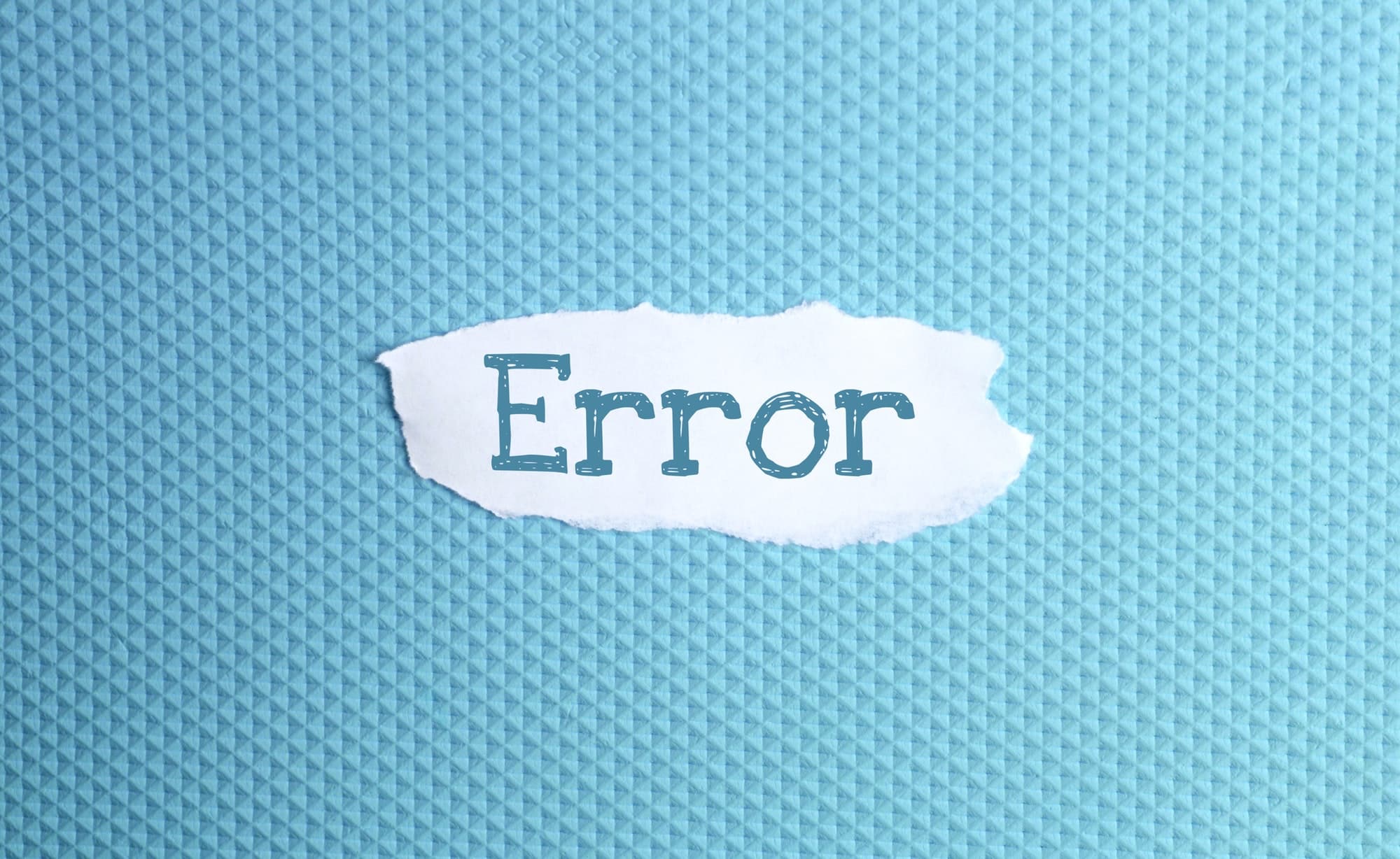 a torn paper written with inscription error on a blue background