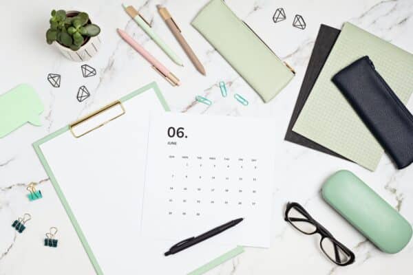 Desktop with calendar for june and office supplies. home office, social media blog