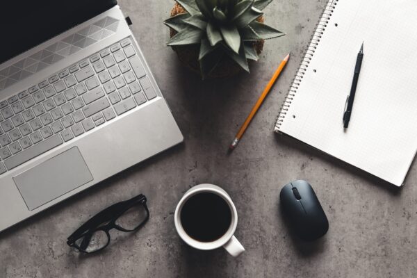 laptop and book, coffee on gray background, Top view of office desk on textured